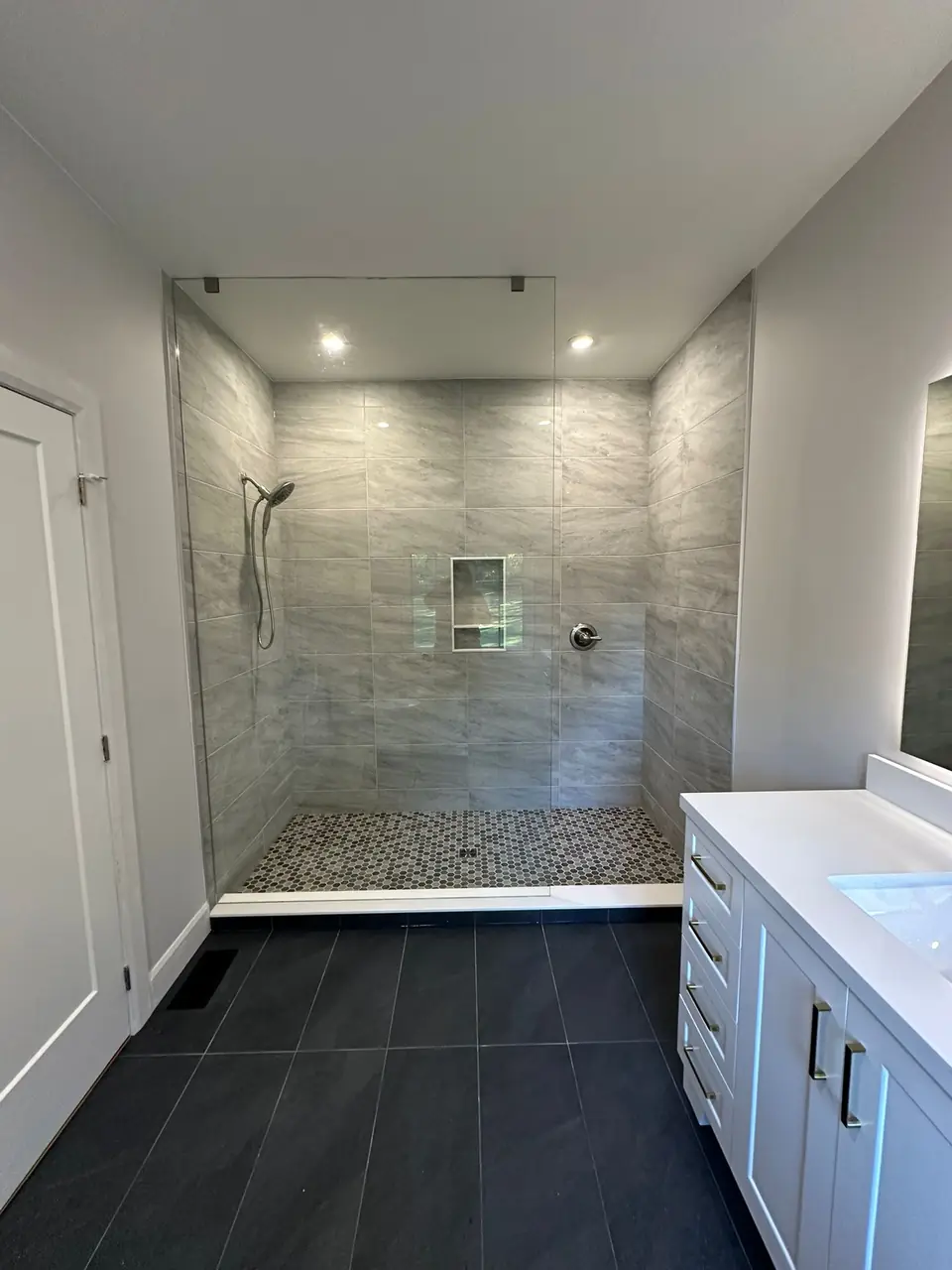 Stone shower wall by MATCON INC.