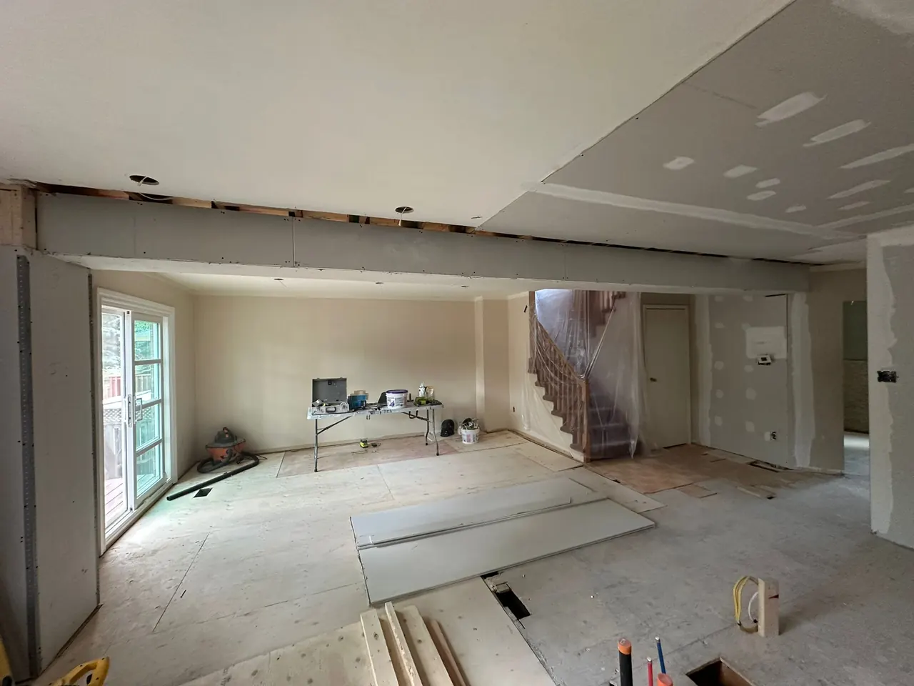 During the renovation: the load-bearing wall removed and a new structural beam installed across the main floor.